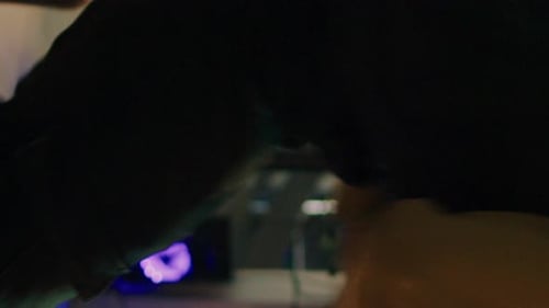 Person Typing on Laptop in front of Monitors