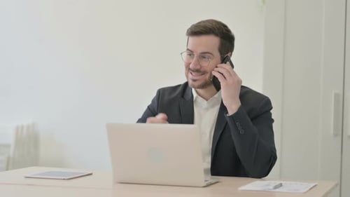 Businessman on Phone in Office Setting