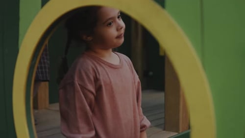 Little Girl Stands on the Playground Looking Around Family Child and Healthy Lifestyle Concept