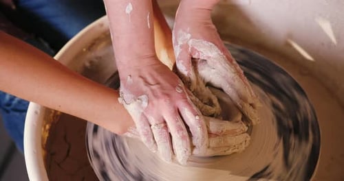 Hands Shaping Clay on a Pottery Wheel