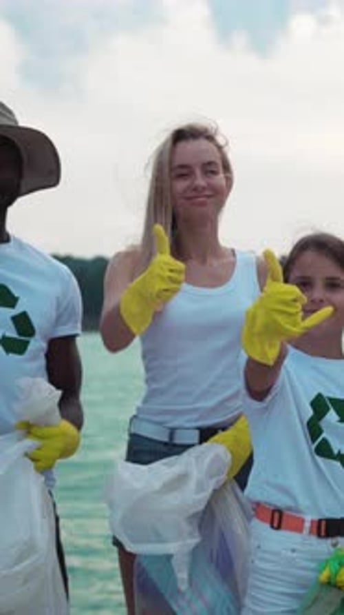 Volunteers Give Thumbs Up After Beach Cleanup