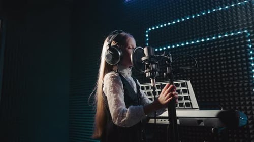 Child Clings to Microphone Stand Dancing