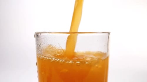 Bright Orange Soda Fills Up a Glass