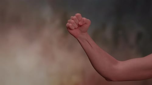 An Empowerment Gesture Symbolized By a Raised Fist Set Against an Inspiring Dramatic Background
