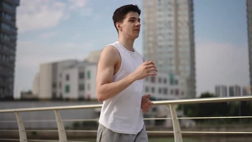 Young Man Jogging in Urban Setting for Fitness