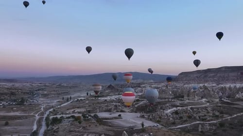 Hot Air Balloons Floating in Valley at Sunrise