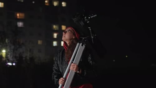 Woman Set Up Telescope for Stargazing at Night