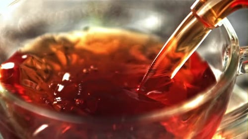 Hot Tea Poured into Glass Cup, Close Up