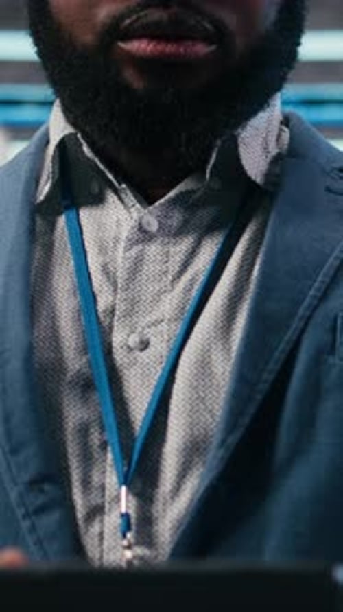 Focused Man Using Tablet in Data Center Workplace