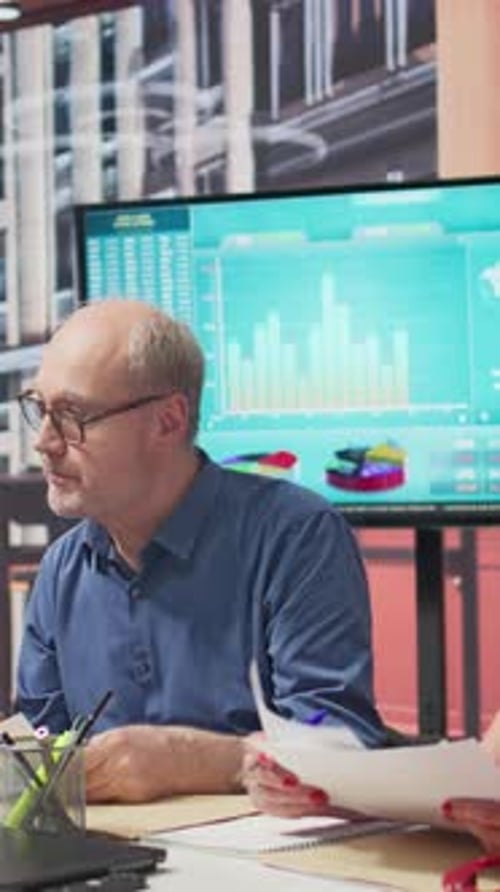 Business Professionals Analyzing Data in Modern Office