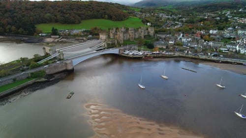 Conwy Castle and three bridges, North Wales, UK. Aerial forward
