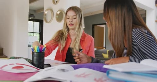 Two Young Adults Study Together at Home