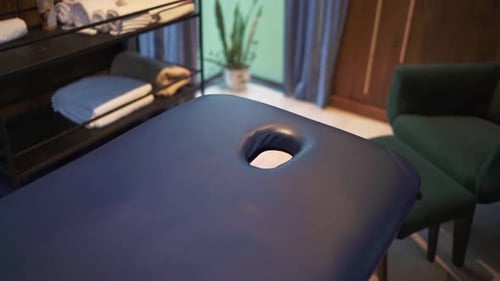 Slow panning camera shot of massage table and room in rustic hotel. South Argentina.
