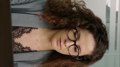 Vertical Screen Concentrated businesswoman working online on computer at office.