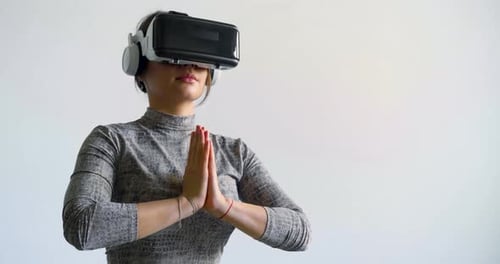 Woman Using VR Headset Meditating in Virtual World