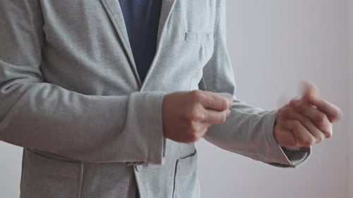 Adult in Blazer Gesticulating with Hands