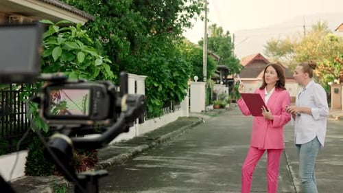 Two Adults Converse on Suburban Street