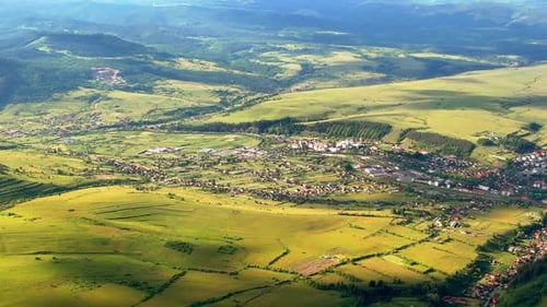 Aerial drone view of Toplita in the Carpathians in Romania. Village, fields and low hills