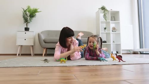Mother and Child Being Engaged in Dinosaur Play in Lounge