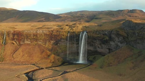 Multiple Waterfalls Cascading Down Tan Cliffs in High, Dry Highlands