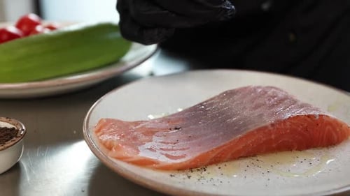 chef prepares a salmon dish in the kitchen. Close-up shots