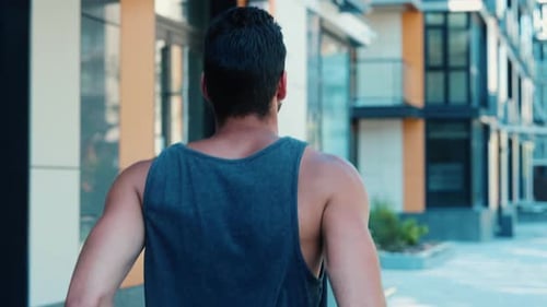 Man Running in Urban Setting on Sunny Day