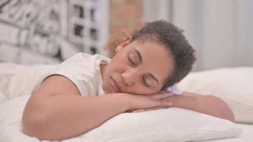 Woman Resting Peacefully in Bed, Close Up