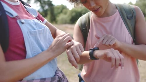 Two Women Hike and Check Smart Watch