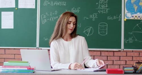 Teacher Explaining Math Problem in Classroom Setting