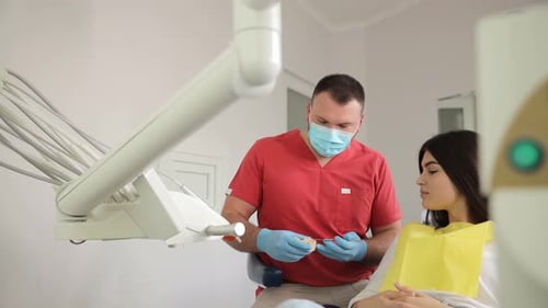 A Dentist Checks a Woman's Teeth at a Dental Office