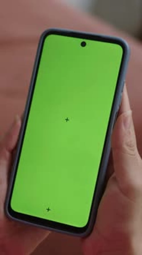 Vertical of Person Scrolling Mobile Phone with Green Screen