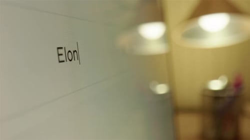 Elon Musk net worth typed into internet browser search bar, closeup tracking