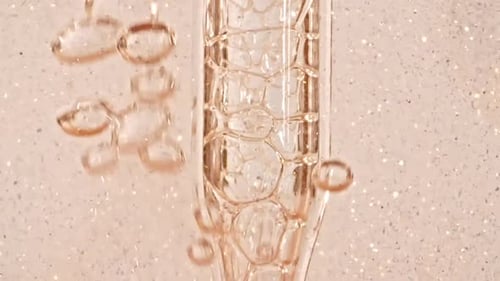 Transparent Cosmetic Gel Fluid With Molecule Bubbles and Oil Flowing in Glass Tube with Clear Liquid