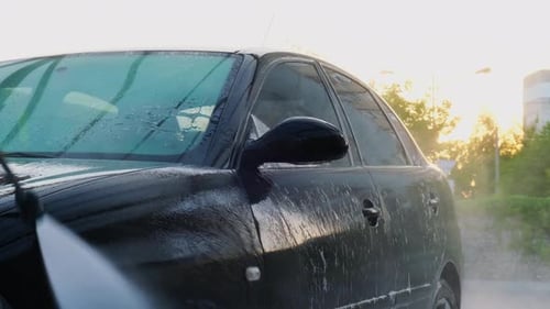 Washing Luxury Black Car on Touchless Car Wash Cleaning the Details of Car Washing Sedan Car with