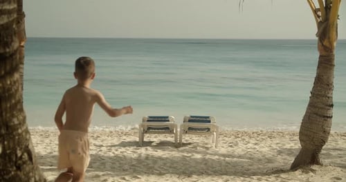 Kids Running to Ocean, Family on Beach at Tropical Resort Aerial