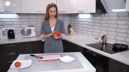 Woman Cuts Vegetables in Modern Kitchen