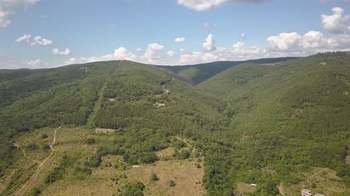 Aerial View of Mountains Covered with Forest Trees with Blue Sky Above