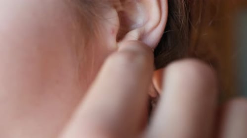 Putting on a Silver Hoop Earring Jewelry