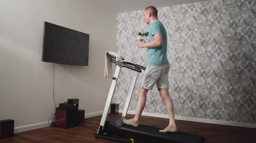 Man Walking Barefoot on Treadmill Indoors