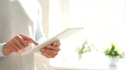 Standing Man Typing on Digital Tablet