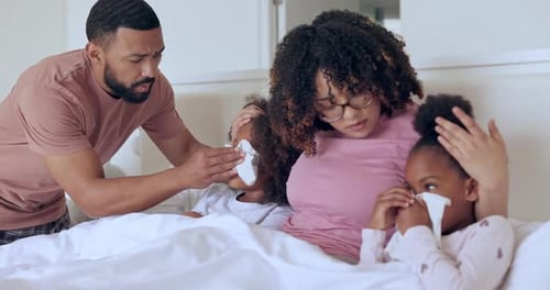 Family, sick children in bed and blowing nose, flu and allergy, virus or bacteria in winter at home