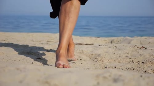 Female Feet Walking on Sand at the Beach with Seascape at Background Legs of Adult Woman Stepping