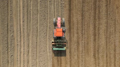 Top View of Tractor Sowing Grain in the Farm Field