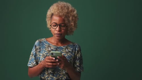 Woman With Blonde Hair Texting on Smartphone