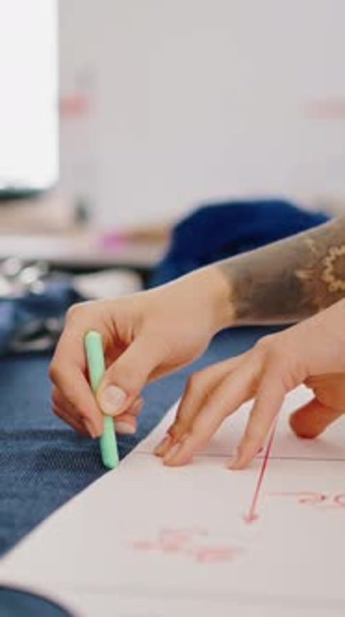 Garment Industry Female Tailor Outlining Cloth Pattern on Blue Fabric at Workshop Tracking Shot Slow