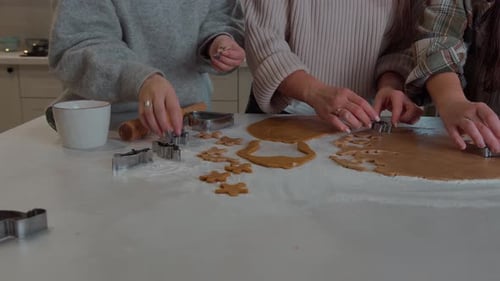 Women Making Gingerbread Cookies in a Kitchen