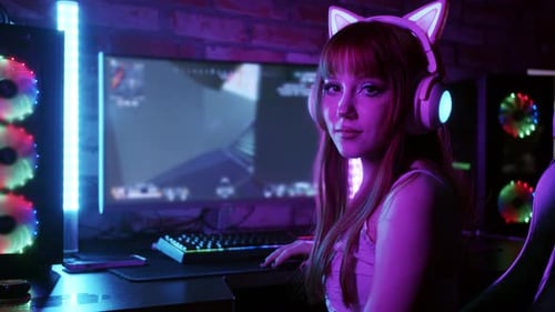 Woman With Headphones Smiling in Blue Lit Room