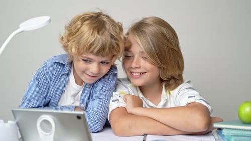 Middle Primary School Students Boy Girl Remotely Studying Writing Book Homework and Tablet at Class
