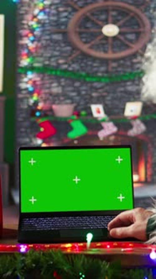 Vertical Video Saint Nicholas Checking His Naughty or Nice List of Kids Next to Chroma Key