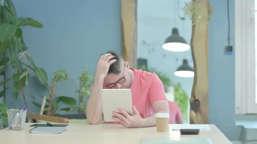 Man Reacts with Shock at Tablet Device